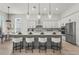Spacious kitchen with an oversized island, pendant lighting, and stainless steel appliances at 8332 Sea Glass Ct, Sarasota, FL 34240