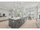Open concept kitchen featuring a large island, stainless steel appliances, and a view of the living area at 8332 Sea Glass Ct, Sarasota, FL 34240