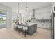 Modern kitchen featuring an island with seating, stainless steel appliances, and a view of the pool at 8332 Sea Glass Ct, Sarasota, FL 34240