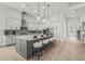 Stylish kitchen featuring an island with seating, pendant lights, and modern finishes at 8332 Sea Glass Ct, Sarasota, FL 34240