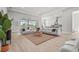 Open-concept living room with a large sectional sofa, natural light, and seamless access to the outdoor pool at 8332 Sea Glass Ct, Sarasota, FL 34240