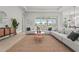 Spacious living room with plush seating, stylish decor, and sliding glass doors overlooking the outdoor pool area at 8332 Sea Glass Ct, Sarasota, FL 34240