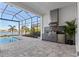 Outdoor kitchen with stainless steel appliances and a pool view at 8332 Sea Glass Ct, Sarasota, FL 34240