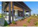 Community pavilion with modern architecture, outdoor seating, and manicured landscaping at 8332 Sea Glass Ct, Sarasota, FL 34240