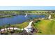 Picturesque pond with a water fountain, walking trail, and gazebo, all beautifully landscaped with palm trees at 8332 Sea Glass Ct, Sarasota, FL 34240
