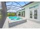 Inviting screened-in pool and spa, featuring a tiled facade with an outdoor kitchen and covered patio at 8332 Sea Glass Ct, Sarasota, FL 34240