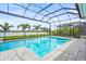 A stunning screened-in pool boasts a spacious patio and tranquil lake view, ideal for relaxation at 8332 Sea Glass Ct, Sarasota, FL 34240