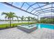 Relaxing pool and spa area with a screened enclosure, complemented by a tranquil lake view at 8332 Sea Glass Ct, Sarasota, FL 34240