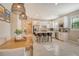 Kitchen dining area with wood table and wicker lighting at 12505 Marsh Pointe Rd, Sarasota, FL 34238