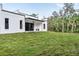 Private backyard with grassy area and modern home at 14135 Carrie Ave, Port Charlotte, FL 33953