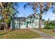Charming light teal home with a walkway and landscaping at 1501 14Th W Ave, Bradenton, FL 34205