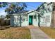 Charming light teal home with a teal door and walkway at 1501 14Th W Ave, Bradenton, FL 34205