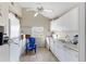 Efficient kitchen with white cabinets, appliances, and vinyl flooring at 1501 14Th W Ave, Bradenton, FL 34205