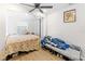 Bedroom with a bed, additional sleeping space, and ceiling fan at 1501 14Th W Ave, Bradenton, FL 34205