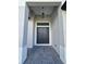 Covered front entry with double doors, a modern light fixture, and tile flooring at 1657 Eugenia Ave, North Port, FL 34288