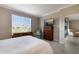 Bright bedroom with lake view, dresser, and comfy chair at 2532 Avolet Ct, Lakewood Ranch, FL 34211