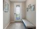 Entryway with bench, mirror, and glass-paned door at 2532 Avolet Ct, Lakewood Ranch, FL 34211