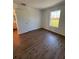 Well-lit bedroom with wood-look floors and large window at 2533 6Th Ave Drive E # 2, Bradenton, FL 34208