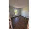 Spacious bedroom with large window and wood-look flooring at 2533 6Th Ave Drive E # 2, Bradenton, FL 34208