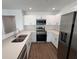 Modern kitchen with white cabinets and stainless steel appliances at 2533 6Th Ave Drive E # 2, Bradenton, FL 34208