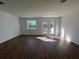 Bright living room featuring hardwood floors and access to balcony at 2533 6Th Ave Drive E # 2, Bradenton, FL 34208