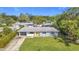 Blue house with yellow door and green lawn, residential area at 2877 Michigan St, Sarasota, FL 34237
