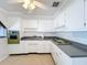Bright kitchen with white cabinets and a ceiling fan at 2877 Michigan St, Sarasota, FL 34237