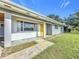 House exterior showcasing a covered porch and yellow front door at 2877 Michigan St, Sarasota, FL 34237