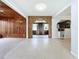 Open dining area with wood paneled walls and view to kitchen at 2877 Michigan St, Sarasota, FL 34237