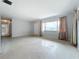 Bright living area with light walls, terrazzo floors, and hallway view at 2877 Michigan St, Sarasota, FL 34237