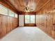 Sunroom with wood paneled walls, ceiling fan and windows at 2877 Michigan St, Sarasota, FL 34237