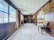 Open living area with wood paneling and view of kitchen at 2877 Michigan St, Sarasota, FL 34237