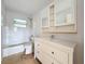 Updated bathroom with white vanity and tiled walls at 2877 Michigan St, Sarasota, FL 34237