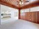Sunroom with wood paneled walls and kitchen view at 2877 Michigan St, Sarasota, FL 34237