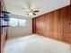 Simple bedroom with wood paneling and ceiling fan at 2877 Michigan St, Sarasota, FL 34237