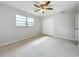 Spacious bedroom with ceiling fan and window at 2877 Michigan St, Sarasota, FL 34237