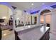 Modern kitchen with a large island and views of the living room and sunset at 309 Ringling Point Dr, Sarasota, FL 34234