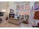 Grand living room boasts a fireplace, high ceilings, and breathtaking sunset views at 309 Ringling Point Dr, Sarasota, FL 34234
