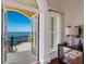 Bedroom with private balcony offering breathtaking water views at 309 Ringling Point Dr, Sarasota, FL 34234