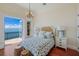 Main bedroom with water views, king-size bed, and hardwood floors at 309 Ringling Point Dr, Sarasota, FL 34234