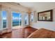 Bedroom with hardwood floors, water views, and access to balcony at 309 Ringling Point Dr, Sarasota, FL 34234