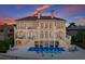 Elegant waterfront home with balconies, a private pool, and manicured grounds offering stunning views at 309 Ringling Point Dr, Sarasota, FL 34234
