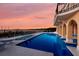 Resort-style pool area overlooking the water at sunset at 309 Ringling Point Dr, Sarasota, FL 34234