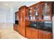 Custom wood cabinetry with glass doors and granite countertops at 309 Ringling Point Dr, Sarasota, FL 34234