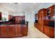 Gourmet kitchen with dark wood cabinetry, granite counters, and stainless steel appliances at 309 Ringling Point Dr, Sarasota, FL 34234