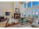 Living room with fireplace, high ceilings, and water views at 309 Ringling Point Dr, Sarasota, FL 34234