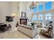 High-ceilinged living room with fireplace and water views at 309 Ringling Point Dr, Sarasota, FL 34234