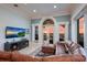 Inviting living room featuring a leather sectional, water view, and access to an outdoor balcony at 309 Ringling Point Dr, Sarasota, FL 34234