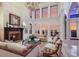 Spacious living room with a fireplace, high ceilings, and stunning sunset views at 309 Ringling Point Dr, Sarasota, FL 34234