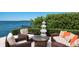 Relaxing waterfront patio with wicker furniture and serene views at 309 Ringling Point Dr, Sarasota, FL 34234